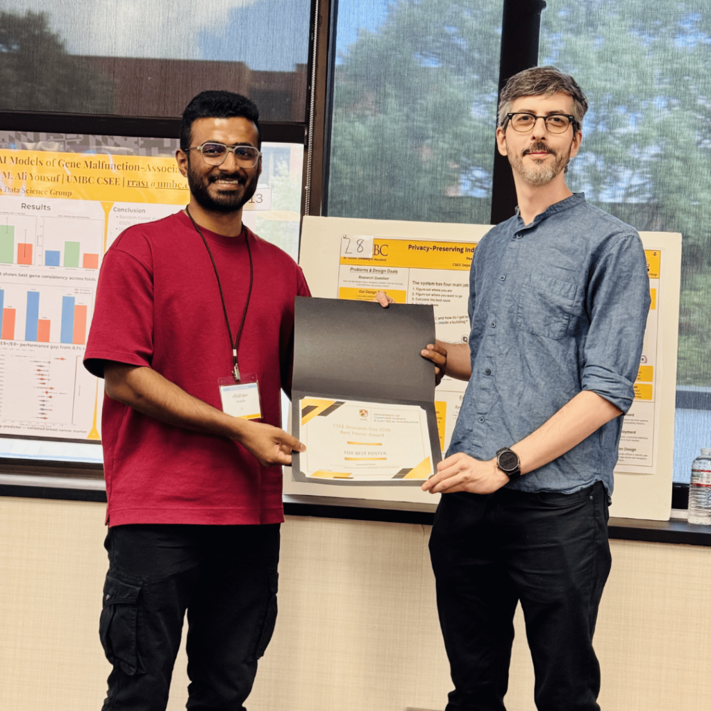 Risshav Guptaa receiving an award for best poster from Dr. Roboto Yus.