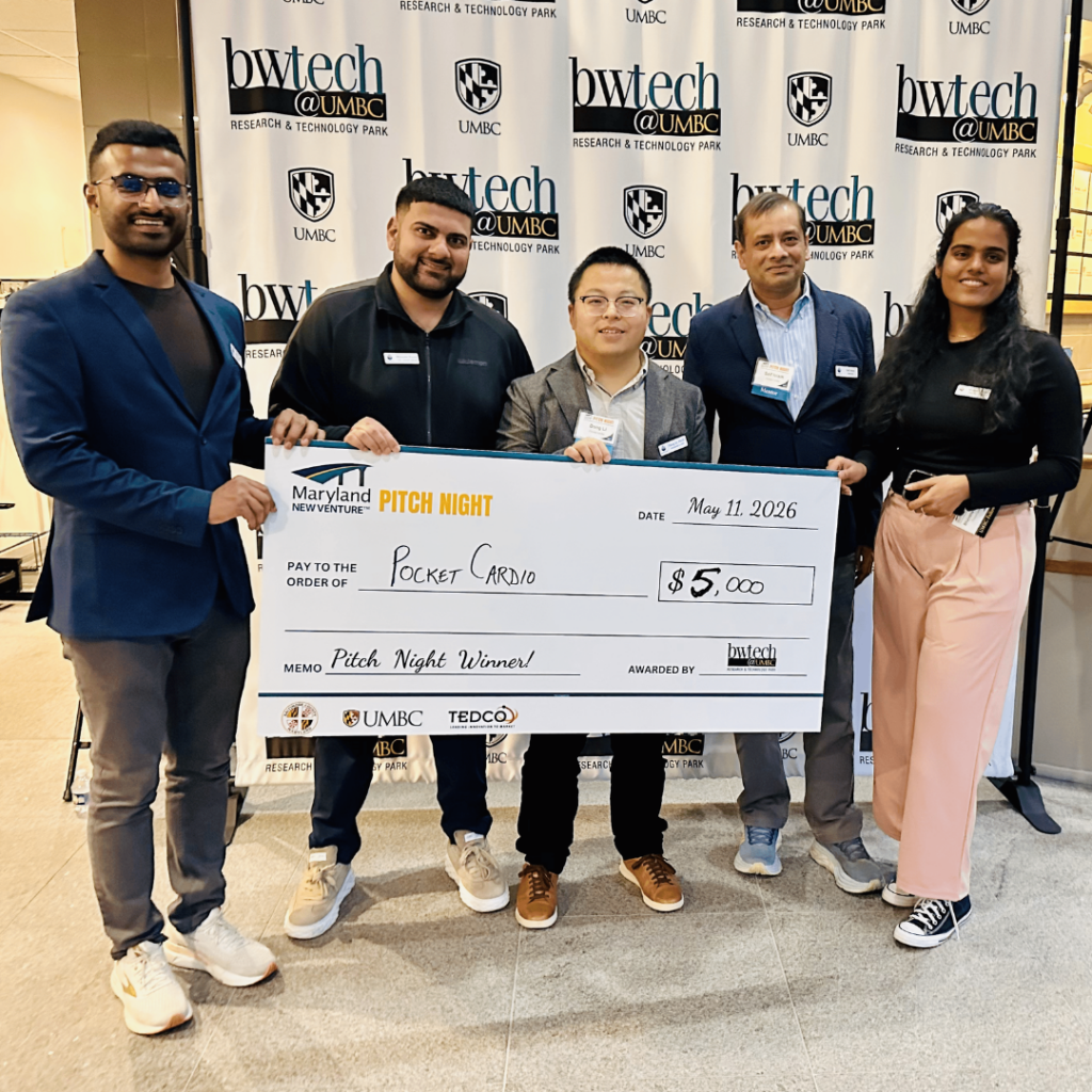 Risshav Guptaa (left) receiving a first place award from The Maryland NEW VENTURE Program.