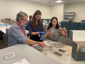Reese Finnigan’s an intern at the U.S. Holocaust Memorial Museum Shapell Research Center looks through black and white photographs of Jewish people before and during WWII.