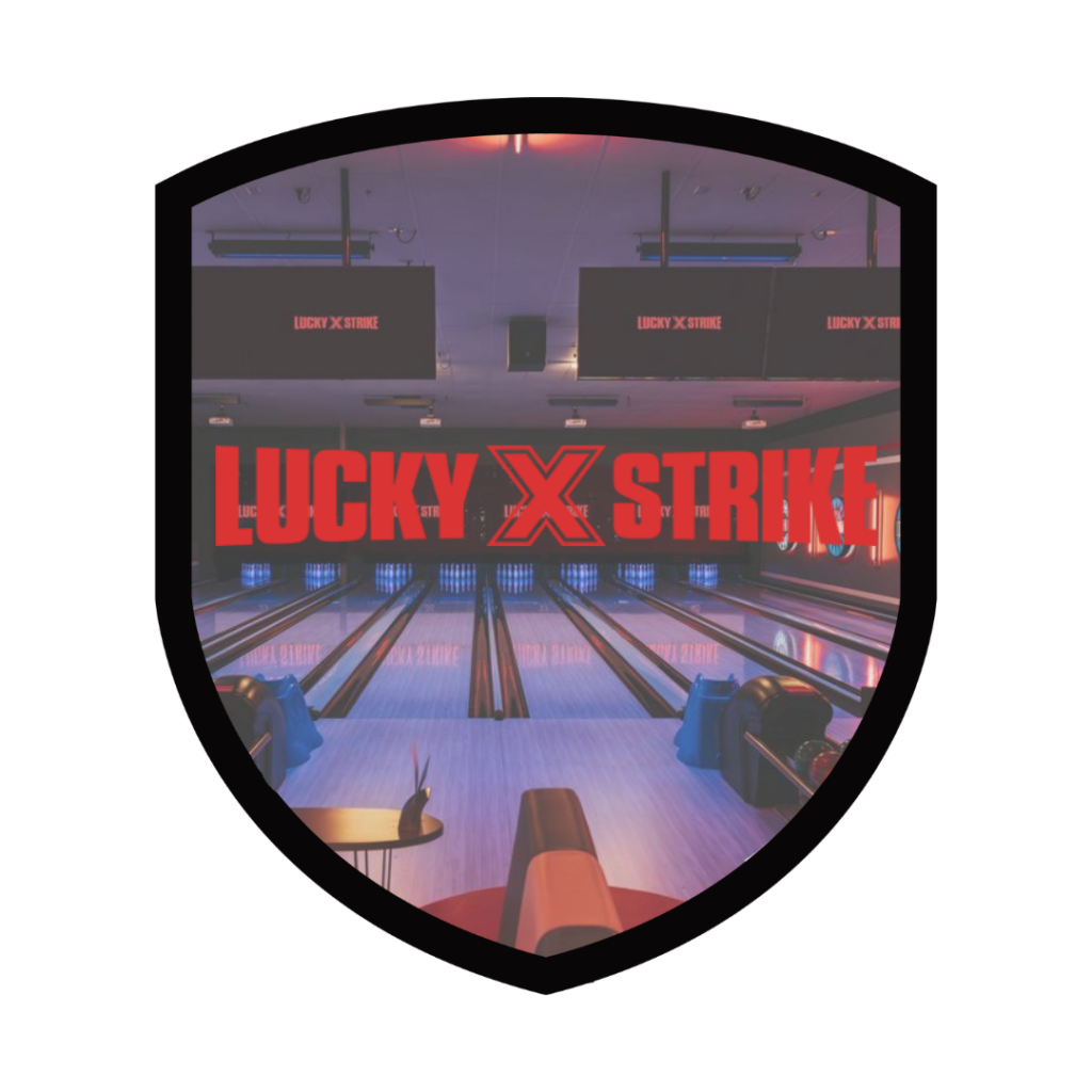 A bowling alley with empty lanes and multiple screens, featuring the text Lucky Strike.