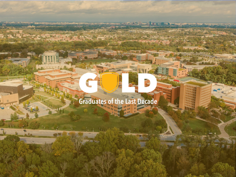 Aerial view of the UMBC campus with text overlay that reads GOLD Graduates of the Last Decade.