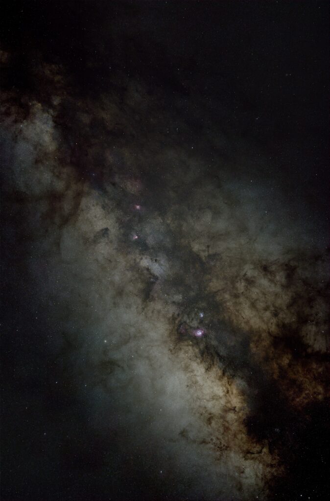 The Milky Way in shades of gray, brown, and pink