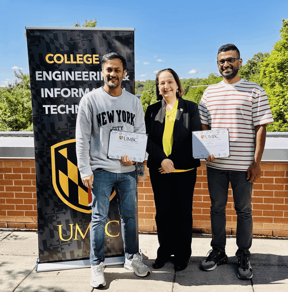 Riishav Guptaa and ASM Mobarak Hossain receiving the COEIT Computing for Social Good Award from Jeanne M. van Briesen, dean of the College off Engineering and Information Technology.