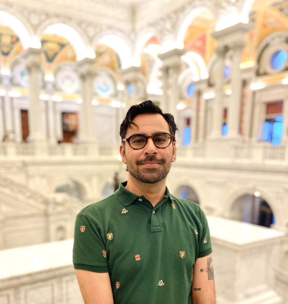 portrait of Mayank Chugh in front of many arches in a large open atrium