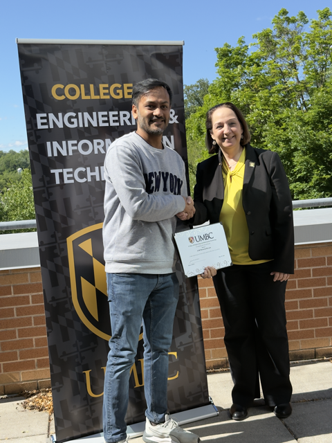 ASM Mobarak Hossain pictured with Dr. Jeanne M. van Briesen, Dean of the College of Engineering and Information Technology, after receiving the COEIT Computing for Social Good Award.