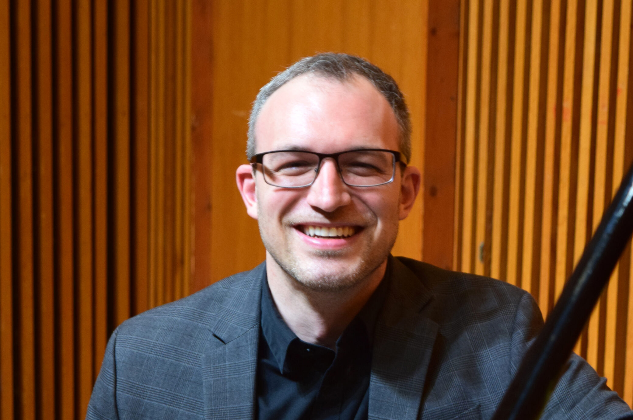A headshot of a person wearing glasses.