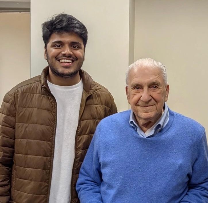 Two men pose for camera.