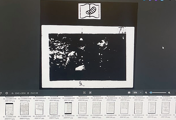 A poor quality black and white photo of two WWII soldiers standing next to each other.
